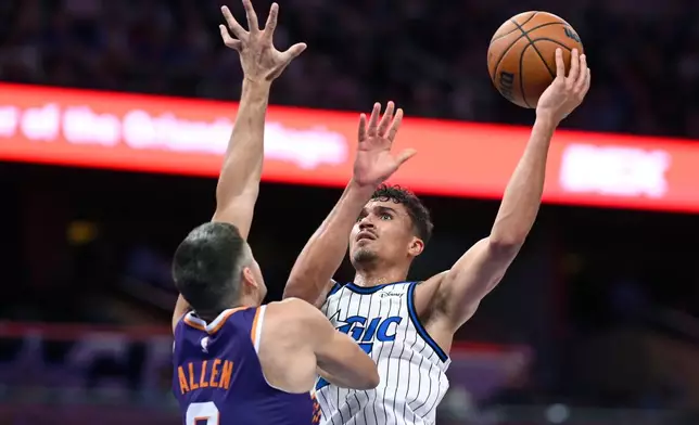 Orlando Magic forward Tristan da Silva, right, goes up to shoot as Phoenix Suns guard Grayson Allen (8) defends during the second half of an NBA basketball game, Tuesday, March 31, 2026, in Orlando, Fla. (AP Photo/Phelan M. Ebenhack)
