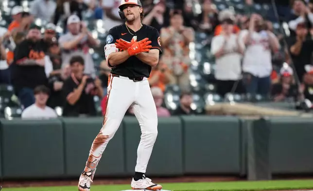 Baltimore Orioles' Gunnar Henderson celebrates after hitting an RBI triple during the third inning of a baseball game against the Arizona Diamondbacks, Monday, April 13, 2026, in Baltimore. (AP Photo/Stephanie Scarbrough)