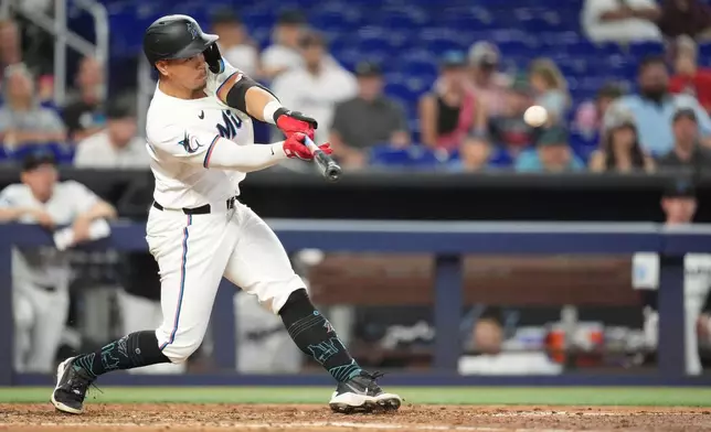 Miami Marlins' Heriberto Hernandez hits a single during the fifth inning of a baseball game against the St. Louis Cardinals, Wednesday, April 22, 2026, in Miami. (AP Photo/Rebecca Blackwell)