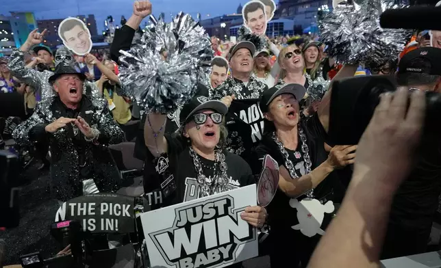 Las Vegas Raiders fans celebrate after Indiana quarterback Fernando Mendoza was chosen by the Las Vegas Raiders with the first overall pick during the first round of the NFL football draft, Thursday, April 23, 2026, in Pittsburgh. (AP Photo/Sue Ogrocki)