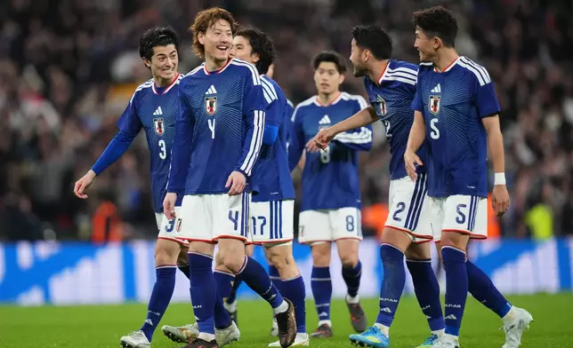 Japan players celebrate after winning the International friendly soccer match between England and Japan in London, Tuesday, March 31, 2026 . (AP Photo/Kirsty Wigglesworth)