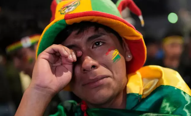 FILE - A Bolivian fans wipes away tears after his country's team loss to Iraq in a World Cup qualifying playoff final soccer match, in La Paz, Bolivia, April 1, 2026. (AP Photo/Juan Karita, File)
