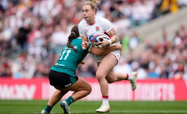 England's Megan Jones, right, and Ireland's Vicky Elmes Kinlan in action during the Women's Six Nations Rugby 2026 match, in London, Saturday, April 11, 2026. (Andrew Matthews/PA via AP)