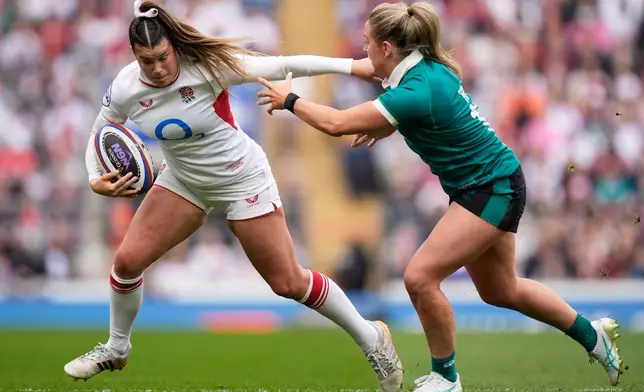 England's Jess Breach, left, and Ireland's Stacey Flood in action during the Women's Six Nations Rugby 2026 match, in London, Saturday, April 11, 2026. (Andrew Matthews/PA via AP)