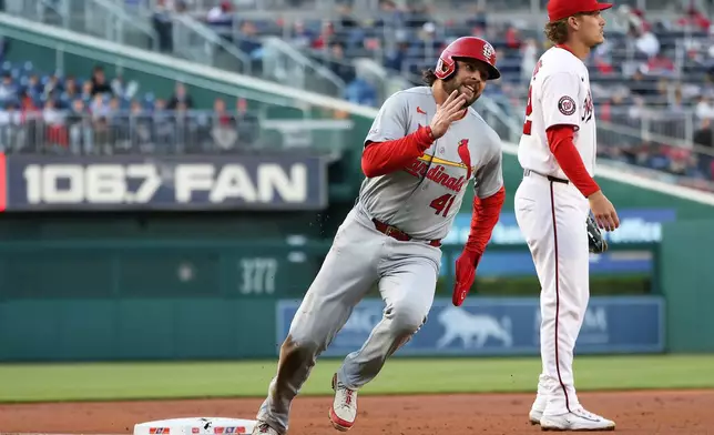 St. Louis Cardinals' Alec Burleson rounds third base and scores during the first inning of a baseball game against the Washington Nationals, Tuesday, April 7, 2026, in Washington. (AP Photo/Daniel Kucin Jr.)