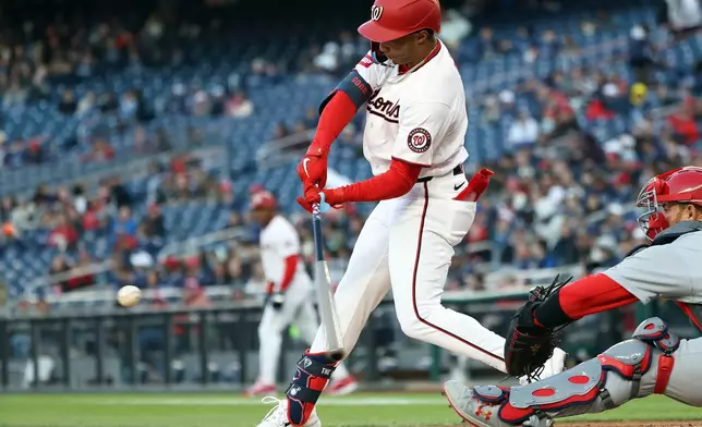 Washington Nationals' Daylen Lile hits an RBI single during the first inning of a baseball game against the St. Louis Cardinals, Tuesday, April 7, 2026, in Washington. (AP Photo/Daniel Kucin Jr.)