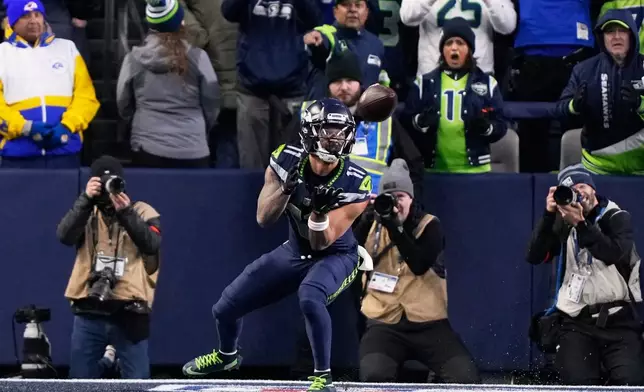 FILE - Seattle Seahawks wide receiver Jaxon Smith-Njigba (11) makes a touchdown catch during the first half of the NFC Championship NFL football game against the Los Angeles Rams, Sunday, Jan. 25, 2026, in Seattle. (AP Photo/Stephen Brashear, File)