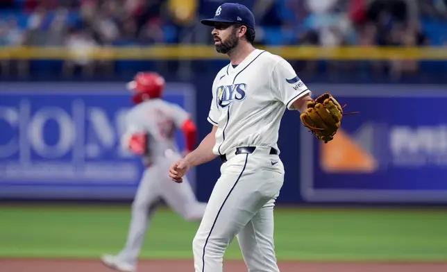Tampa Bay Rays pitcher Jesse Scholtens walks back to the mound as Cincinnati Reds' Sal Stewart runs the bases after his two-run home run during the first inning of a baseball game Monday, April 20, 2026, in St. Petersburg, Fla. (AP Photo/Chris O'Meara)