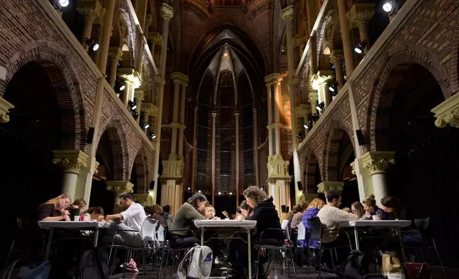 Participants take part in a digital detox evening of the Offline Club in Amsterdam, Netherlands, Tuesday, April 7, 2026. (AP Photo/Peter Dejong)