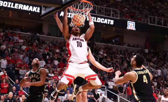 Arizona forward Koa Peat (10) dunks during the second half in the Elite Eight of the NCAA college basketball tournament against Purdue, Saturday, March 28, 2026, in San Jose, Calif. (AP Photo/Kelley L Cox)