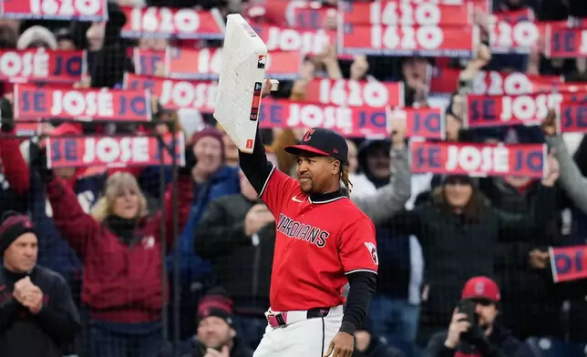 Cleveland Guardians third baseman José Ramírez holds the base after being presented with it after the fifth inning of a baseball game against the Kansas City Royals to commemorate his record 1,620 games as a Cleveland Indian/Cleveland Guardian in Cleveland, Monday, April 6, 2026. (AP Photo/Sue Ogrocki)