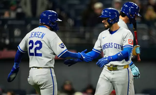 Kansas City Royals' Jonathan India, right, celebrates with teammate Carter Jensen (22) after both scores on India's two-run home run in the eighth inning of a baseball game against the Cleveland Guardians in Cleveland, Monday, April 6, 2026. (AP Photo/Sue Ogrocki)