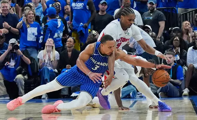 Orlando Magic guard Desmond Bane (3) goes after a loose ball against Detroit Pistons guard Ausar Thompson during the second half in Game 4 of a first-round NBA basketball playoff series, Monday, April 27, 2026, in Orlando, Fla. (AP Photo/John Raoux)