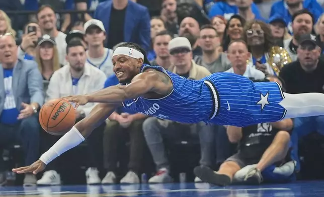 Orlando Magic center Wendell Carter Jr. dives for a loose ball during the first half in Game 4 of a first-round NBA basketball playoff series against the Detroit Pistons, Monday, April 27, 2026, in Orlando, Fla. (AP Photo/John Raoux)