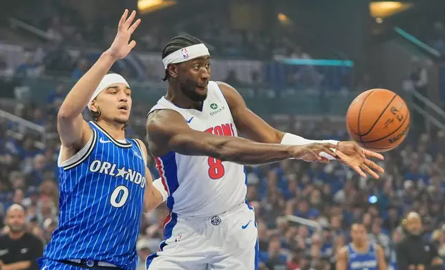 Detroit Pistons guard Caris LeVert (8) passes the ball as Orlando Magic guard Anthony Black (0) defends during the first half in Game 4 of a first-round NBA basketball playoff series, Monday, April 27, 2026, in Orlando, Fla. (AP Photo/John Raoux)