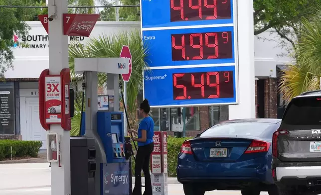 A customer pays for gasoline at a Mobil gas station, Wednesday, April 1, 2026, in Miami, Fla. (AP Photo/Marta Lavandier)