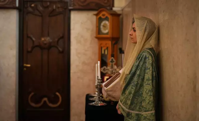 A woman leans on a wall during Easter Sunday Mass at Saint Sarkis Cathedral, an Armenian Apostolic church, in Tehran, Iran, Sunday, April 5, 2026. (AP Photo/Francisco Seco)