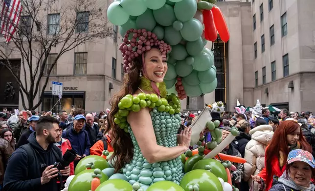 Tommi May wears a costume of balloons as they participate in the Easter Bonnet Parade on Fifth Avenue, Sunday, April 5, 2026, in New York. (AP Photo/Adam Gray)