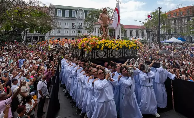 Worshippers carry a figure of Jesus Christ during an Easter procession through Panama City's old town, Sunday, April 5, 2026. (AP Photo/Matias Delacroix)