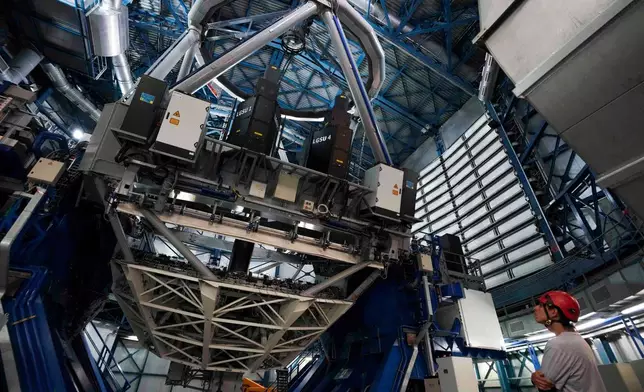 An operator looks at a Very Large Telescope at the Paranal Observatory operated by the European Southern Observatory in the Atacama Desert, Chile, Monday, April 13, 2026. (AP Photo/Esteban Felix)