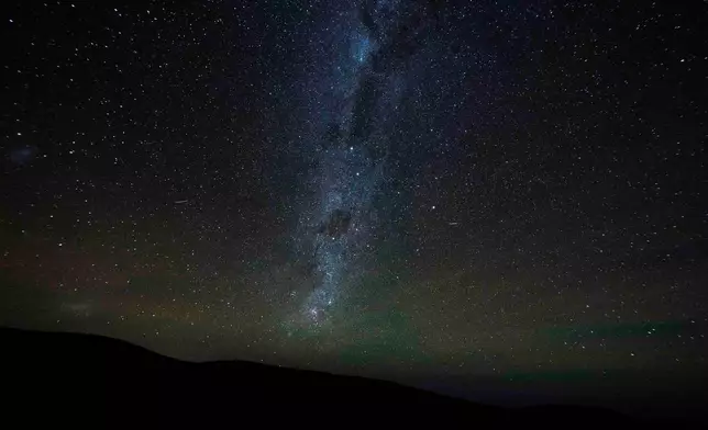 The Milky Way stretches across the night sky as seen from the Atacama Desert, Chile, Wednesday, April 15, 2026. (AP Photo/Esteban Felix)