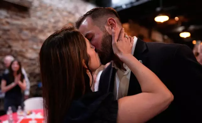 Republican candidate Clay Fuller, right, kisses his wife, Kate, as election results roll in during an election night watch party, Tuesday, April 7, 2026, in Ringgold, Ga. (AP Photo/Mike Stewart)