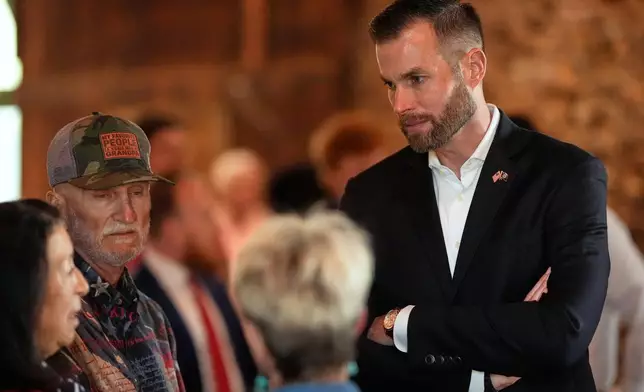 Republican candidate Clay Fuller, right, speaks to supporters during an election night watch party, Tuesday, April 7, 2026, in Ringgold, Ga. (AP Photo/Mike Stewart)