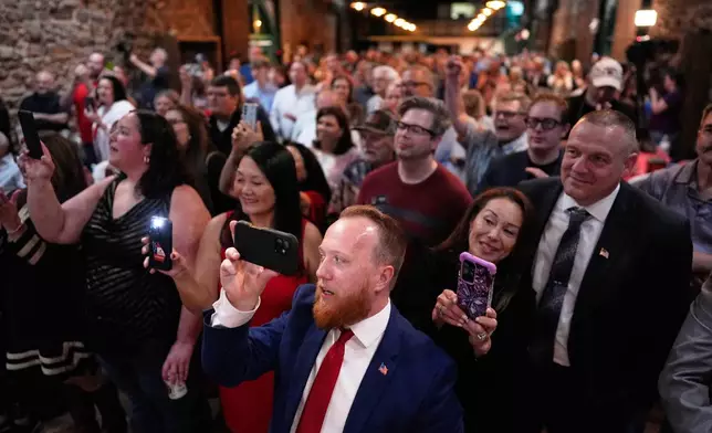 Attendees listen as Republican Clay Fuller speaks during an election night watch party after winning a special election for Georgia's 14th Congressional District, Tuesday, April 7, 2026, in Ringgold, Ga. (AP Photo/Mike Stewart)