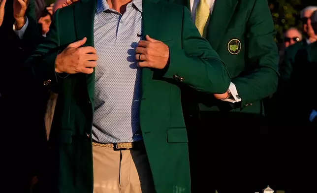 FILE - Augusta National Golf Club chairman Fred Ridley puts the green Jacket on Rory McIlroy, of Northern Ireland, after the Masters golf tournament at the Augusta National Golf Club, April 12, 2026, in Augusta, Ga. (AP Photo/David J. Phillip, File)