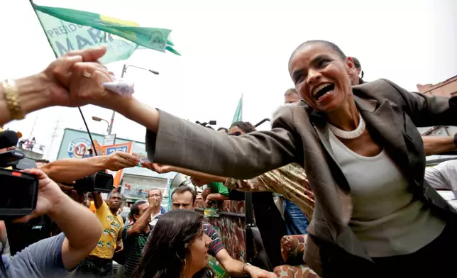 FILE - Marina Silva, right, presidential candidate for the Green Party, greets supporters during a campaign rally in Rio de Janeiro, Brazil, Oct. 2, 2010. (AP Photo/Natacha Pisarenko, File)
