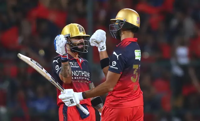 Royal Challengers Bengaluru's Virat Kohli celebrates his fifty runs with batting partner Devdutt Padikkal during the Indian Premier League cricket match between Royal Challengers Bengaluru and Gujarat Titans in Bengaluru, India, Friday, April 24, 2026. (AP Photo)