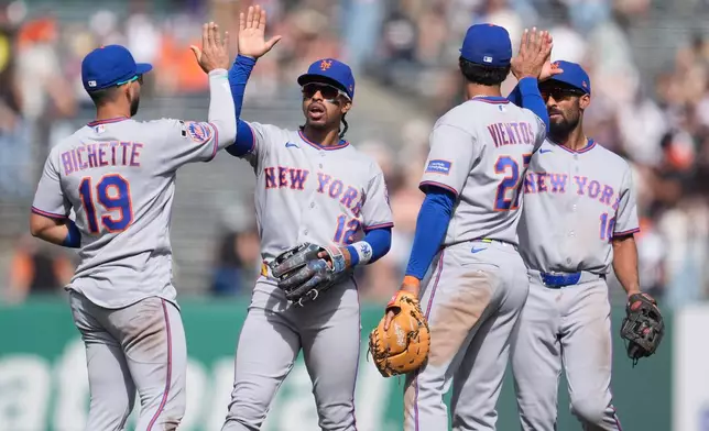 New York Mets' Bo Bichette, from left, celebrates with Francisco Lindor, Mark Vientos and Marcus Semien after a baseball game against the San Francisco Giants in San Francisco, Sunday, April 5, 2026. (AP Photo/Jeff Chiu)