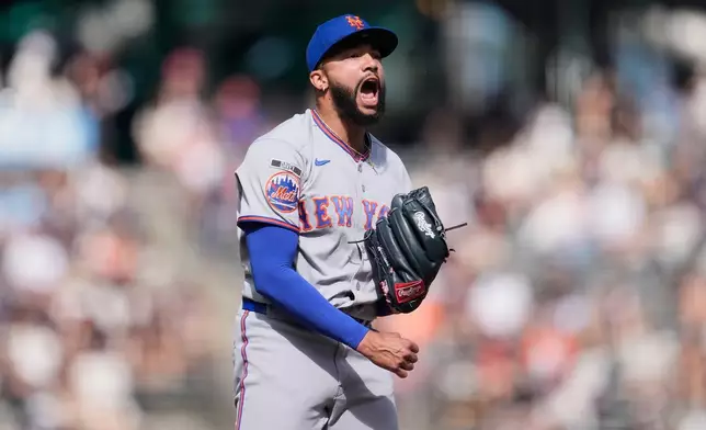 New York Mets pitcher Devin Williams celebrates after striking out San Francisco Giants' Jung Hoo Lee during the ninth inning of a baseball game in San Francisco, Sunday, April 5, 2026. (AP Photo/Jeff Chiu)