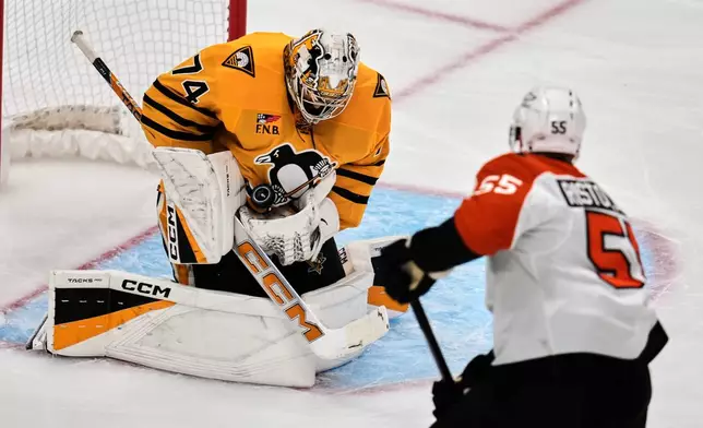 Pittsburgh Penguins goaltender Stuart Skinner (74) blocks a shot by Philadelphia Flyers' Rasmus Ristolainen (55) during the first period of Game 2 in the first round of the NHL Stanley Cup playoffs in Pittsburgh, Monday, April 20, 2026. (AP Photo/Gene J. Puskar)