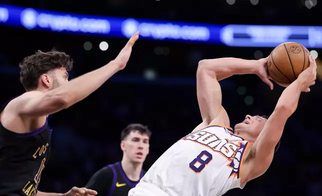Phoenix Suns guard Grayson Allen (8) prepares to shoot against Los Angeles Lakers forward Maxi Kleber, left, as Lakers forward Jake LaRavia, back center, watches during the first half of an NBA basketball game, Friday, April 10, 2026, in Los Angeles. (AP Photo/Jessie Alcheh)