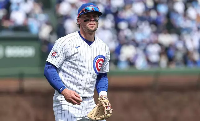 Chicago Cubs second baseman Nico Hoerner (2) warms up before a baseball game against the Washington Nationals at Wrigley Field on Sunday, March 29, 2026, in Chicago. (AP Photo/Geoff Stellfox)
