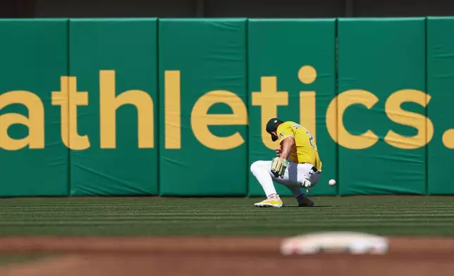 Athletics left fielder Tyler Soderstrom misses a ball hit by Houston Astros' Christian Vázquez during the third inning of a baseball game Saturday, April 4, 2026, in West Sacramento, Calif. (AP Photo/Sara Nevis)
