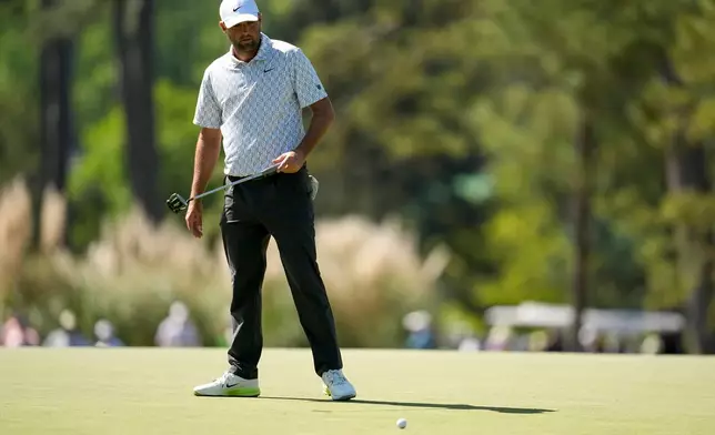 Scottie Scheffler reacts after missing a putt on the third hole during the second round of the Masters golf tournament at the Augusta National Golf Club, Friday, April 10, 2026, in Augusta, Ga. (AP Photo/Ashley Landis)