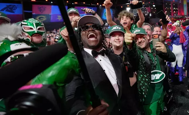 Texas Tech linebacker David Bailey poses with fans after being chosen by the New York Jets with the second overall pick during the first round of the NFL football draft, Thursday, April 23, 2026, in Pittsburgh. (AP Photo/Sue Ogrocki)