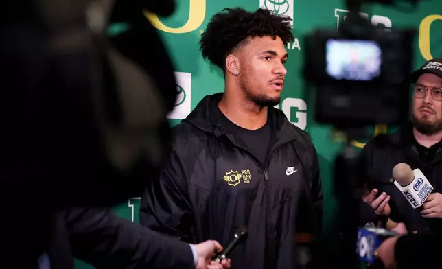 FILE - Oregon tight end Kenyon Sadiq (18) talks to the press at the school's NFL Pro Day, Tuesday, March 17, 2026, in Eugene, Ore. (AP Photo/Amanda Loman,File)
