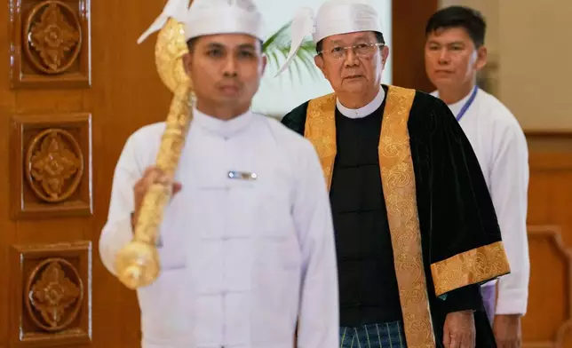 Parliament chairman Aung Lin Dwe, center, arrives for a session of Union Parliament in Naypyitaw, Myanmar, Friday, April 3, 2026. (AP Photo/Aung Shine Oo)