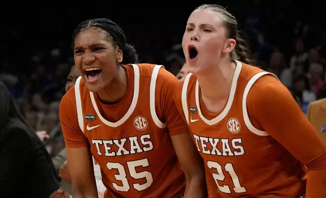 Texas forward Madison Booker (35) and Texas guard Ashton Judd (21) celebrate against UCLA during the second half of a women's NCAA college basketball tournament semifinal game at the Final Four, Friday, April 3, 2026, in Phoenix. (AP Photo/Ross D. Franklin)