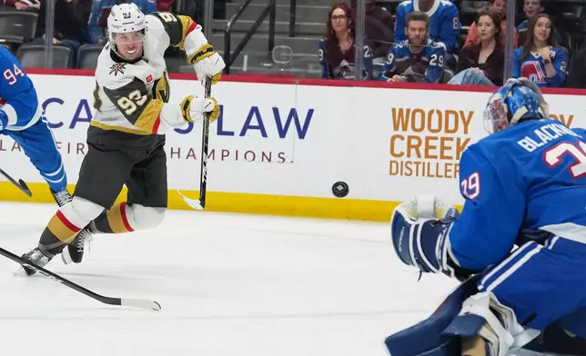 Vegas Golden Knights right wing Mitch Marner, left, puts a shot on Colorado Avalanche goaltender MacKenzie Blackwood in the second period of an NHL hockey game Saturday, April 11, 2026, in Denver. (AP Photo/David Zalubowski)