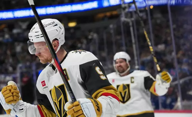 Vegas Golden Knights center Jack Eichel, front, reacts after scoring the winning goal as right wing Mark Stone celebrates in overtime of an NHL hockey game against the Colorado Avalanche Saturday, April 11, 2026, in Denver. (AP Photo/David Zalubowski)