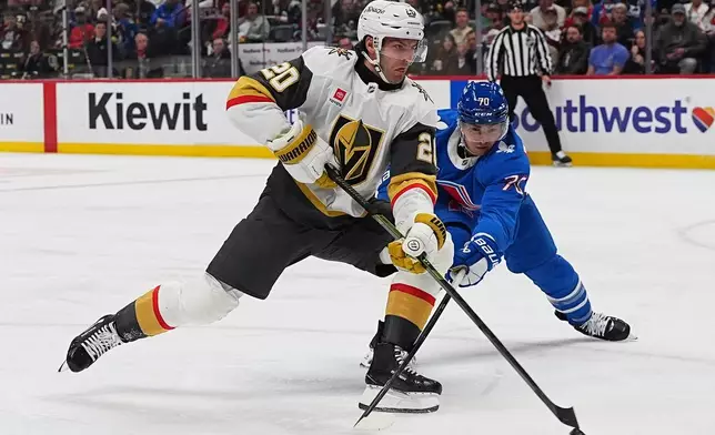 Vegas Golden Knights left wing Brandon Saad (20) drives past Colorado Avalanche defenseman Sam Malinski (70) in the second period of an NHL hockey game Saturday, April 11, 2026, in Denver. (AP Photo/David Zalubowski)