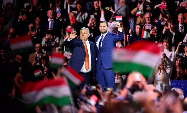 Hungary's Prime Minister Viktor Orban, left, and U.S. Vice President JD Vance gesture at the end of a pre-election rally in Budapest, Hungary, Tuesday, April 7, 2026. (AP Photo/Denes Erdos)