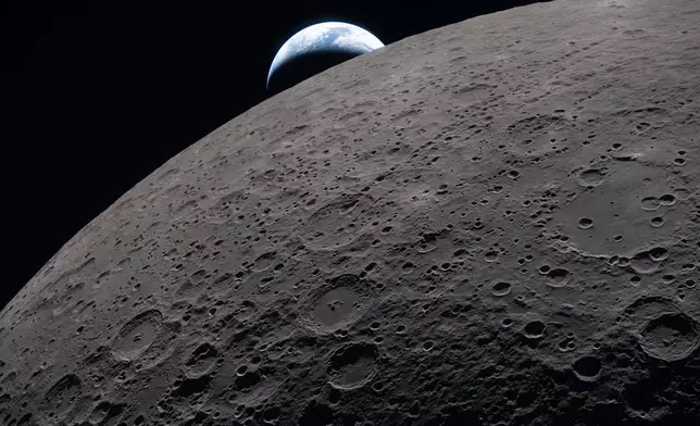 In this image provided by NASA, the Artemis II crew captured this view as the Earth sets behind the Moon during a lunar flyby, Monday, April 6, 2026. (NASA via AP)
