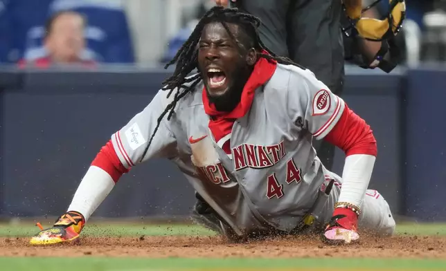 Cincinnati Reds' Elly de la Cruz reacts after scoring on a wild pitch by Miami Marlins relief pitcher Anthony Bender during the ninth inning of a baseball game, Tuesday, April 7, 2026, in Miami. (AP Photo/Lynne Sladky)