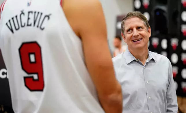 FILE - Chicago Bulls President and CEO Michael Reinsdorf, right, talks with Nikola Vucevic during the NBA basketball team's media day, Oct. 2, 2023, in Chicago. (AP Photo/Charles Rex Arbogast, File)