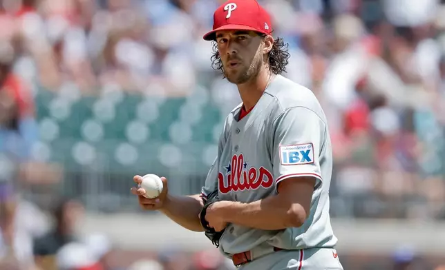 Philadelphia Phillies starting pitcher Aaron Nola (27) reacts after giving up a three-run home run to Atlanta Braves first baseman Matt Olson during the first inning of a baseball game, Sunday, April 26, 2026, in Atlanta. (AP Photo/Erik S. Lesser)